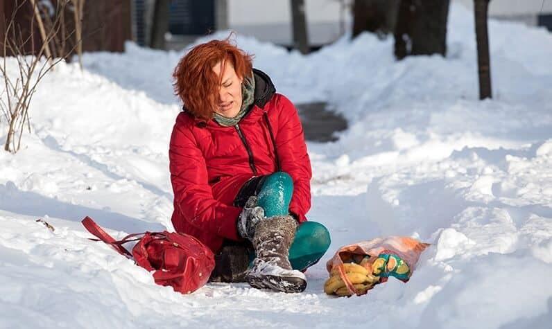 an injured women sitting on snow