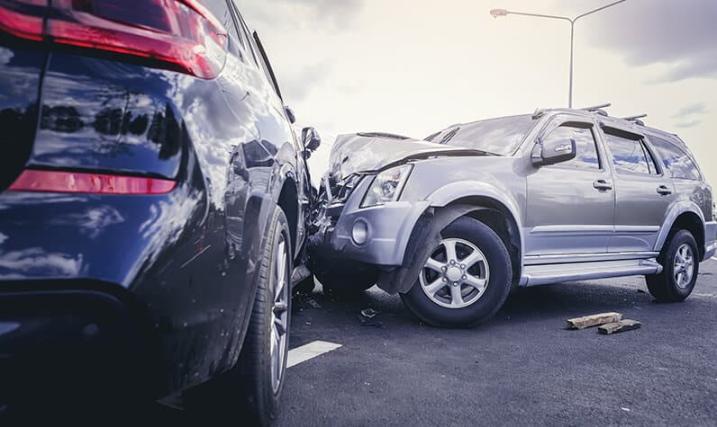 a damaged car with dents after a collision with another vehicle